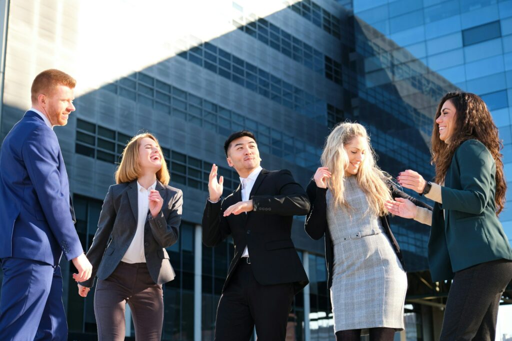 Businesspeople dancing excited for growth, successful sale or profit target.