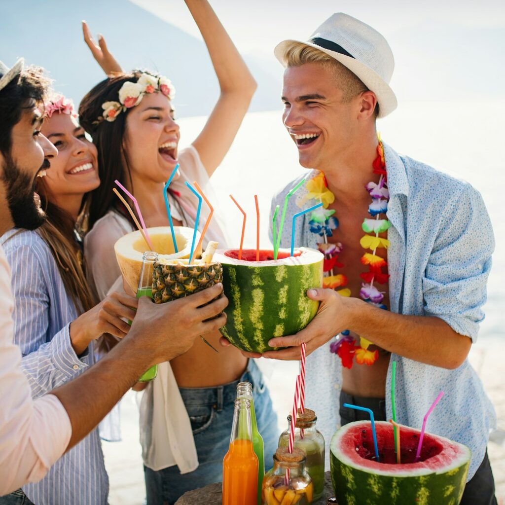 Summer, vacation, party, people concept. Group of friends having fun and party on the beach