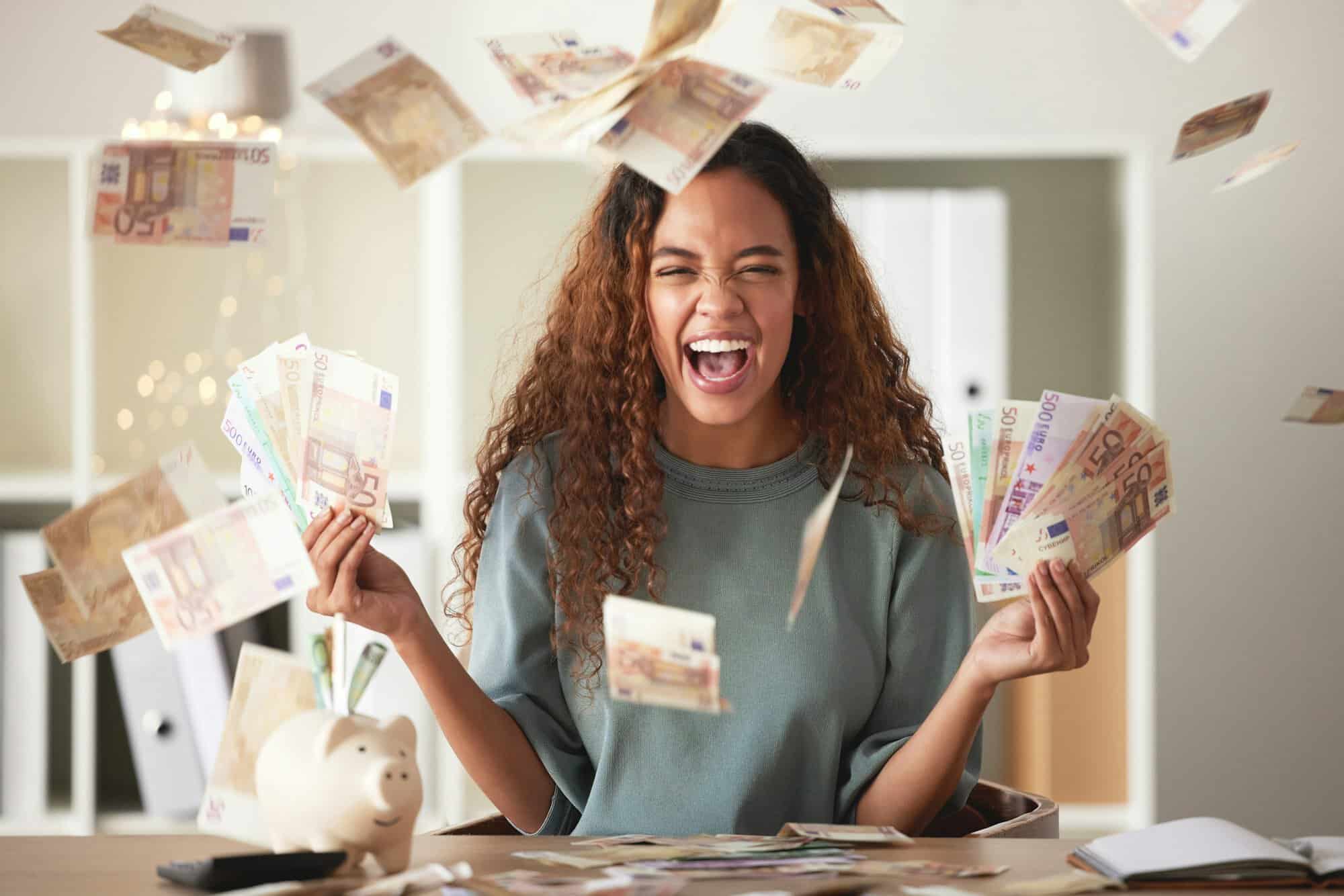 One happy young mixed race woman feeling rich and successful while throwing money at home. Excited