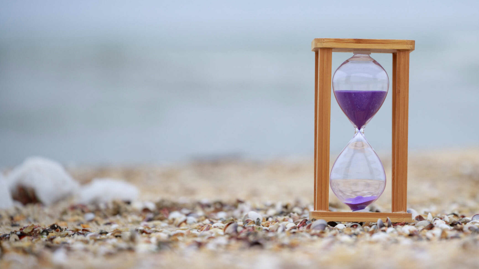 Hourglass at the beach on the ground. High quality photo